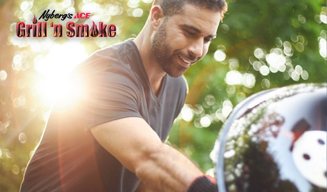 A man putting meat onto a smoker